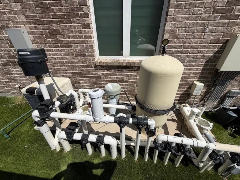 Pool equipment pad with pump, filter and plumbing at a Frisco home