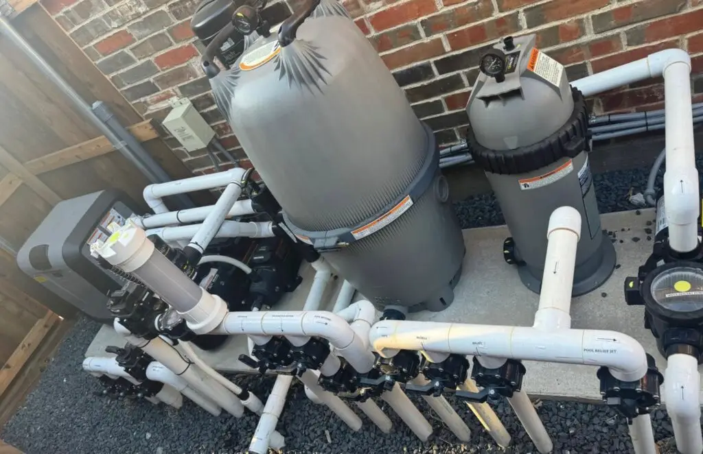 Aging pool pump and filter on an equipment pad due for replacement