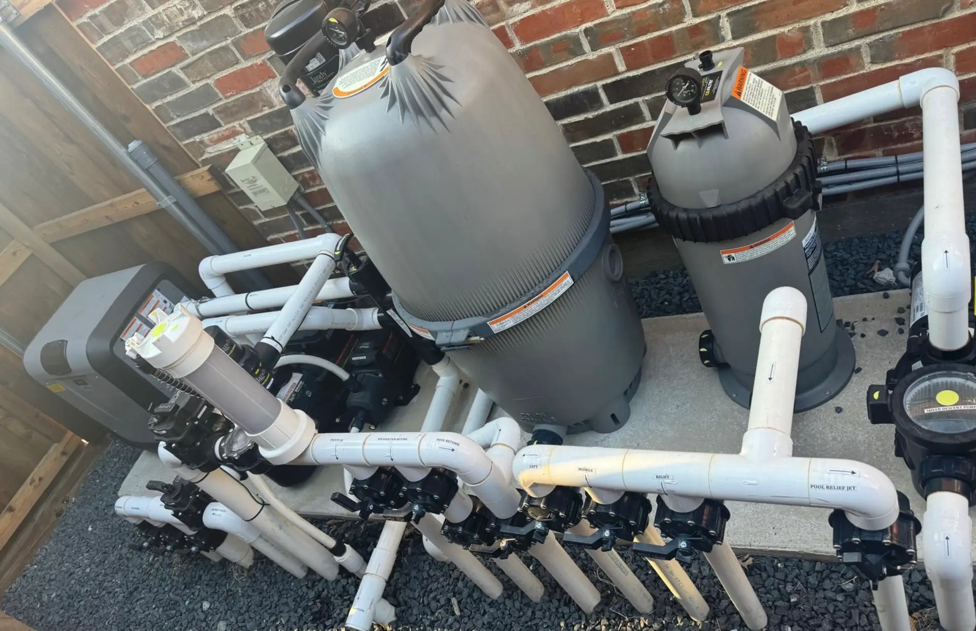 Aging pool pump and filter on an equipment pad due for replacement