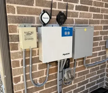 Pool automation control panel with gauges mounted on a brick wall